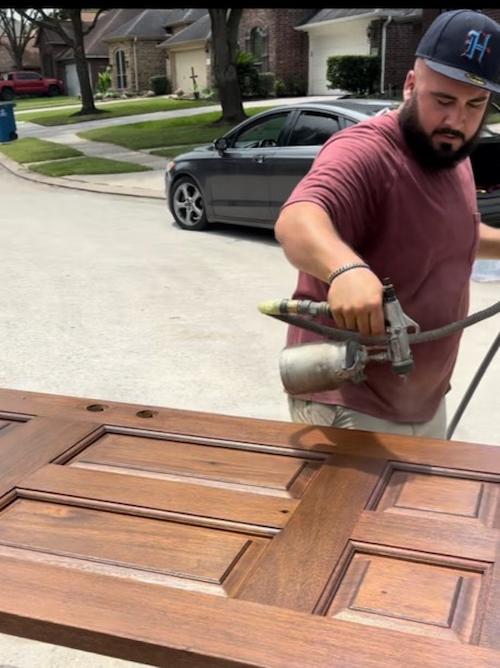 Chris spraying new life into wooden door in Katy, Texas